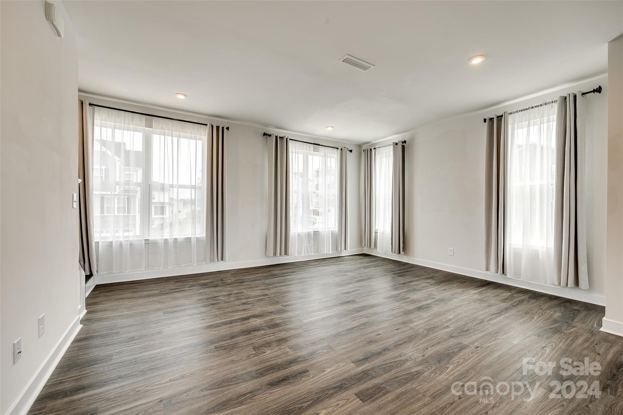 664 Crudent Road Tega Cay, SC 29708 - Photo 12 of 34 a view of an empty room with wooden floor and a window