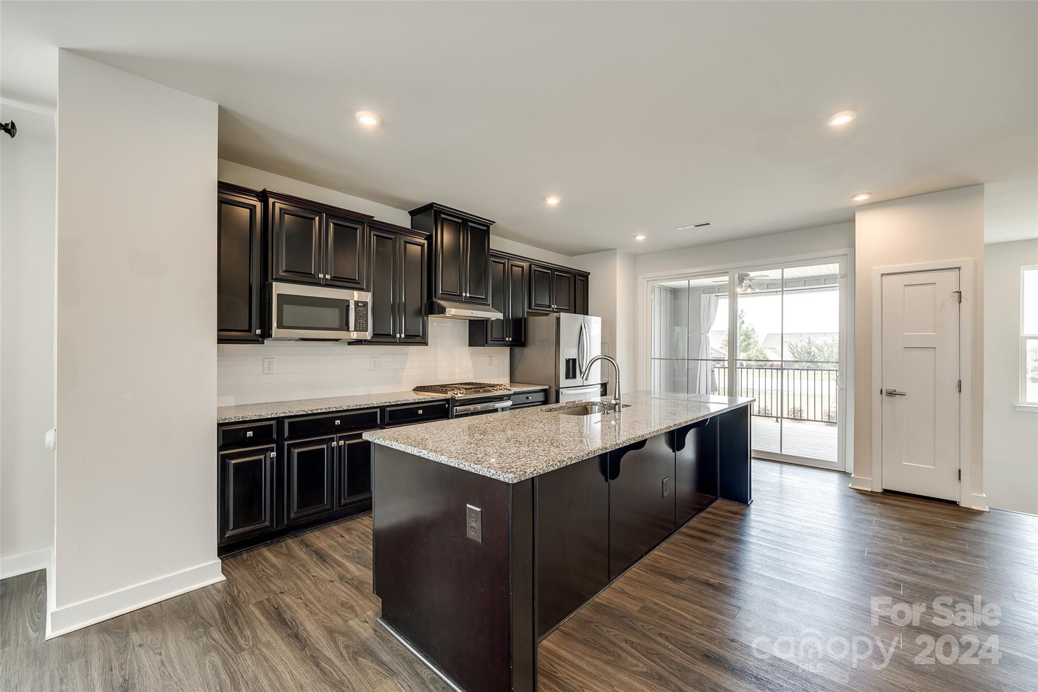 664 Crudent Road Tega Cay, SC 29708 - Photo 15 of 34 a large kitchen with stainless steel appliances granite countertop a stove and a sink