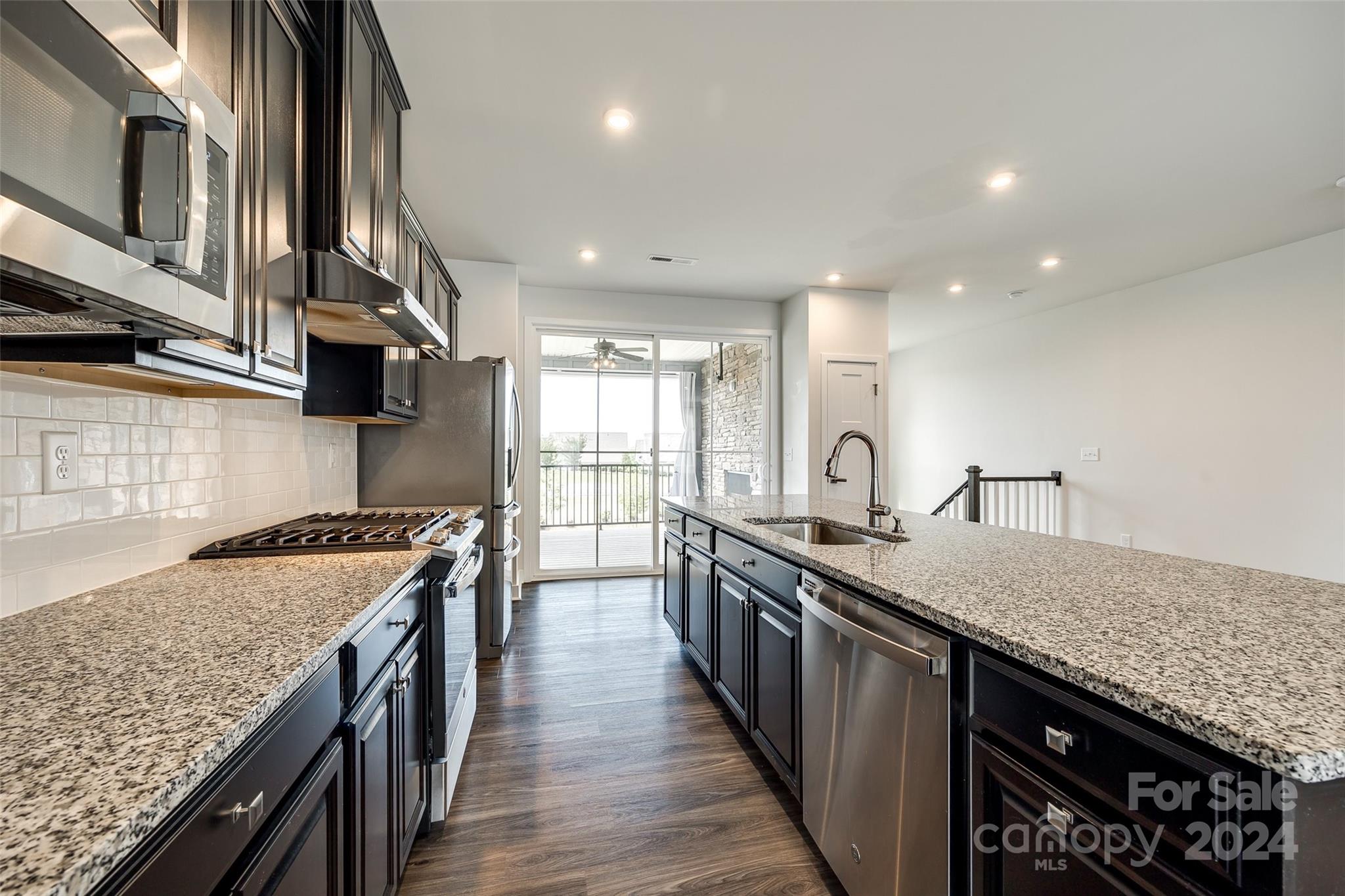 664 Crudent Road Tega Cay, SC 29708 - Photo 16 of 34 a kitchen with stainless steel appliances granite countertop a stove a sink and a refrigerator