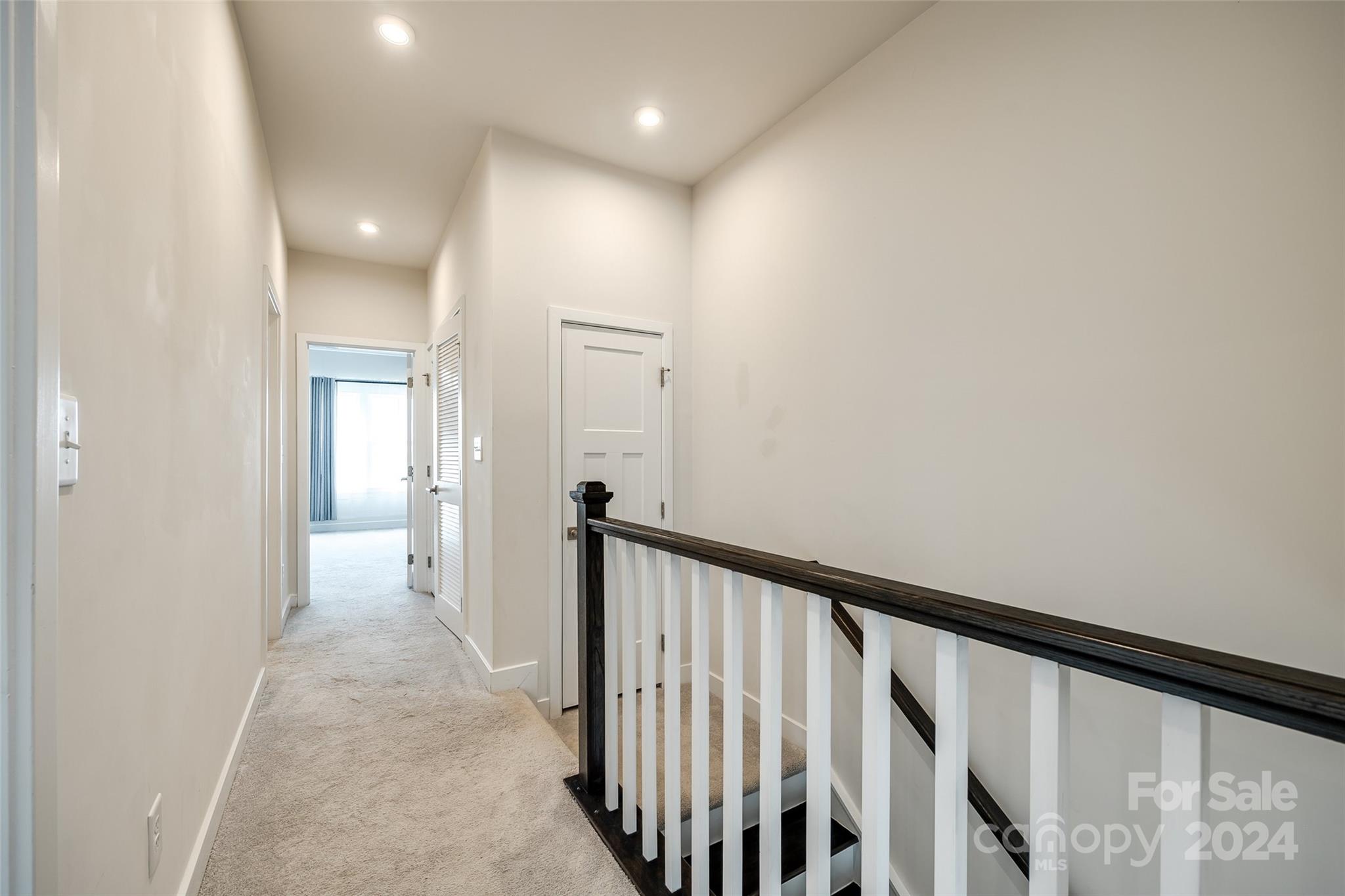 664 Crudent Road Tega Cay, SC 29708 - Photo 19 of 34 a view of a hallway with wooden floor and staircase