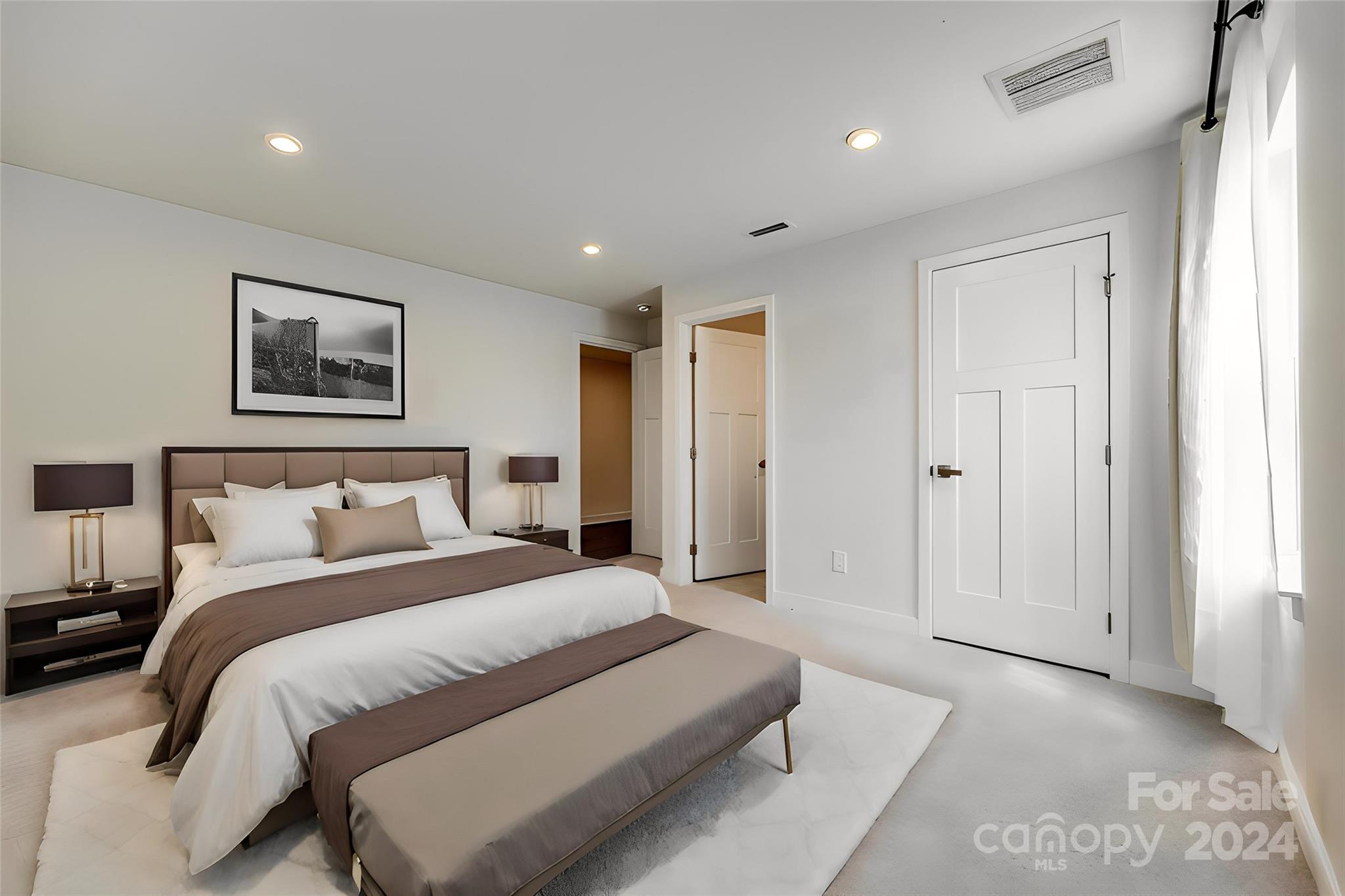 664 Crudent Road Tega Cay, SC 29708 - Photo 20 of 34 a spacious bedroom with a bed and a painting