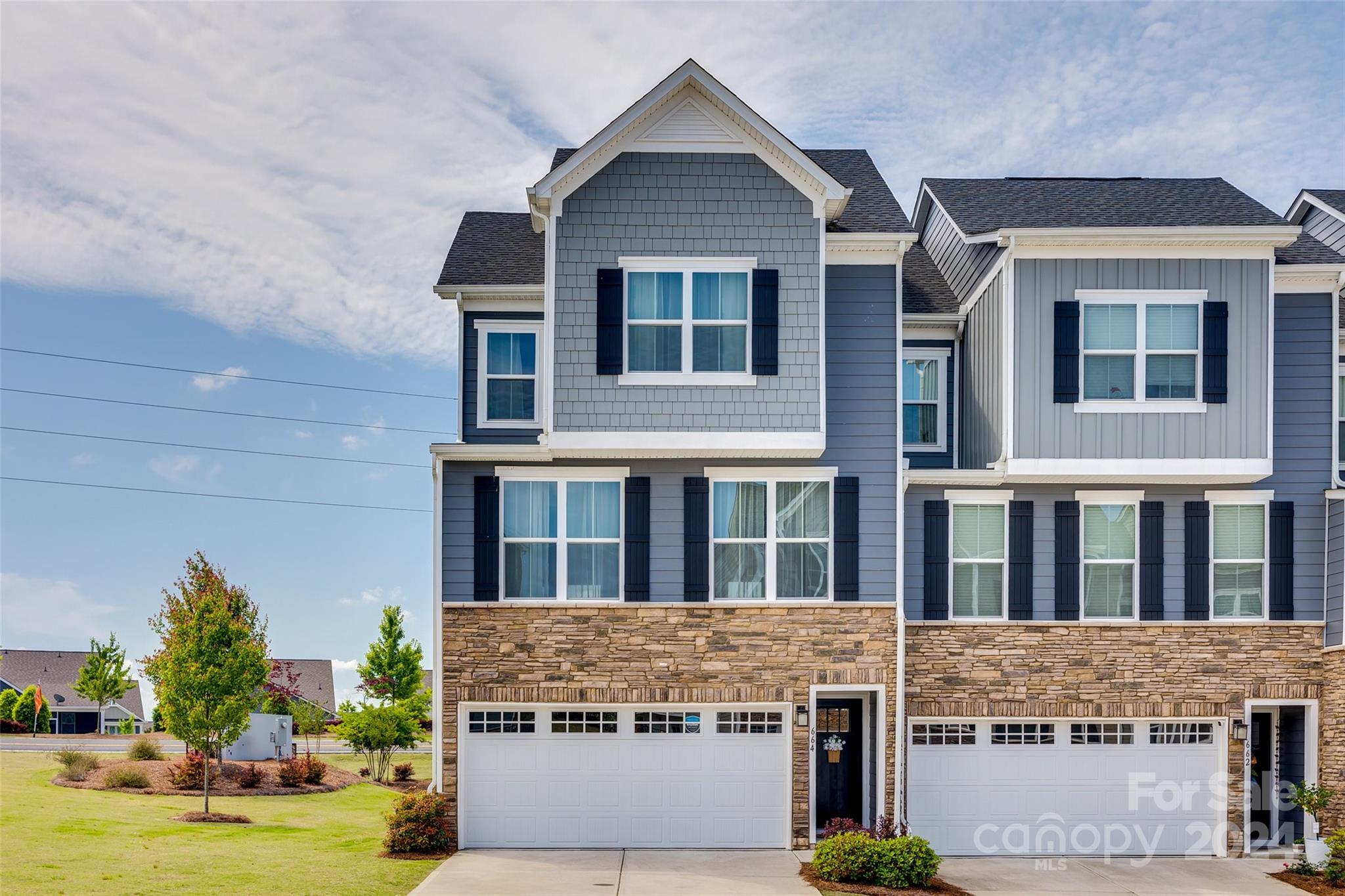 664 Crudent Road Tega Cay, SC 29708 - Photo 2 of 34 a front view of a house with garden