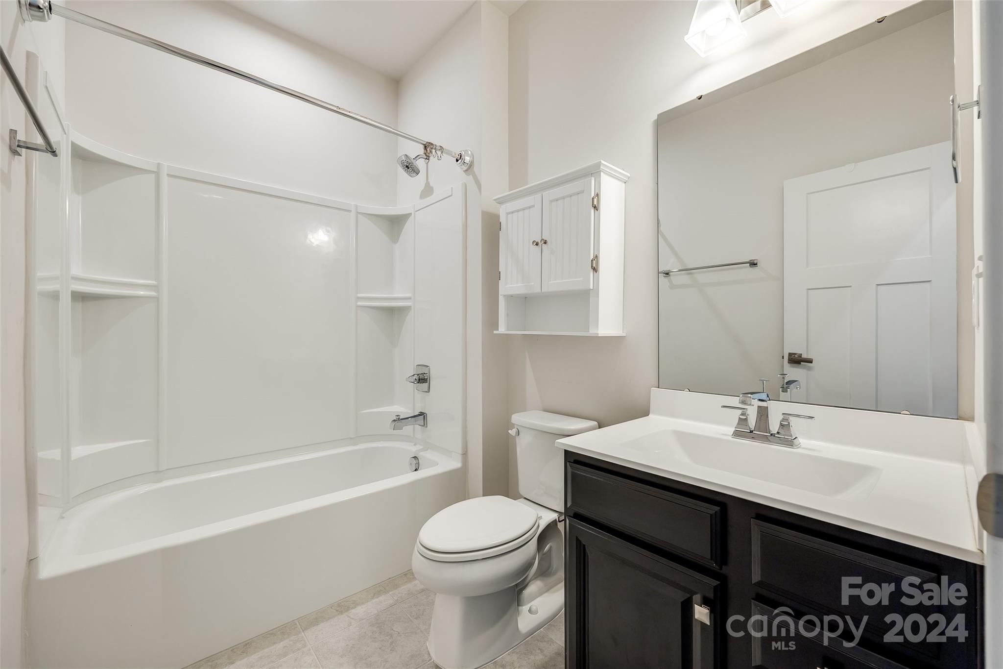 664 Crudent Road Tega Cay, SC 29708 - Photo 23 of 34 a bathroom with a sink a toilet and shower