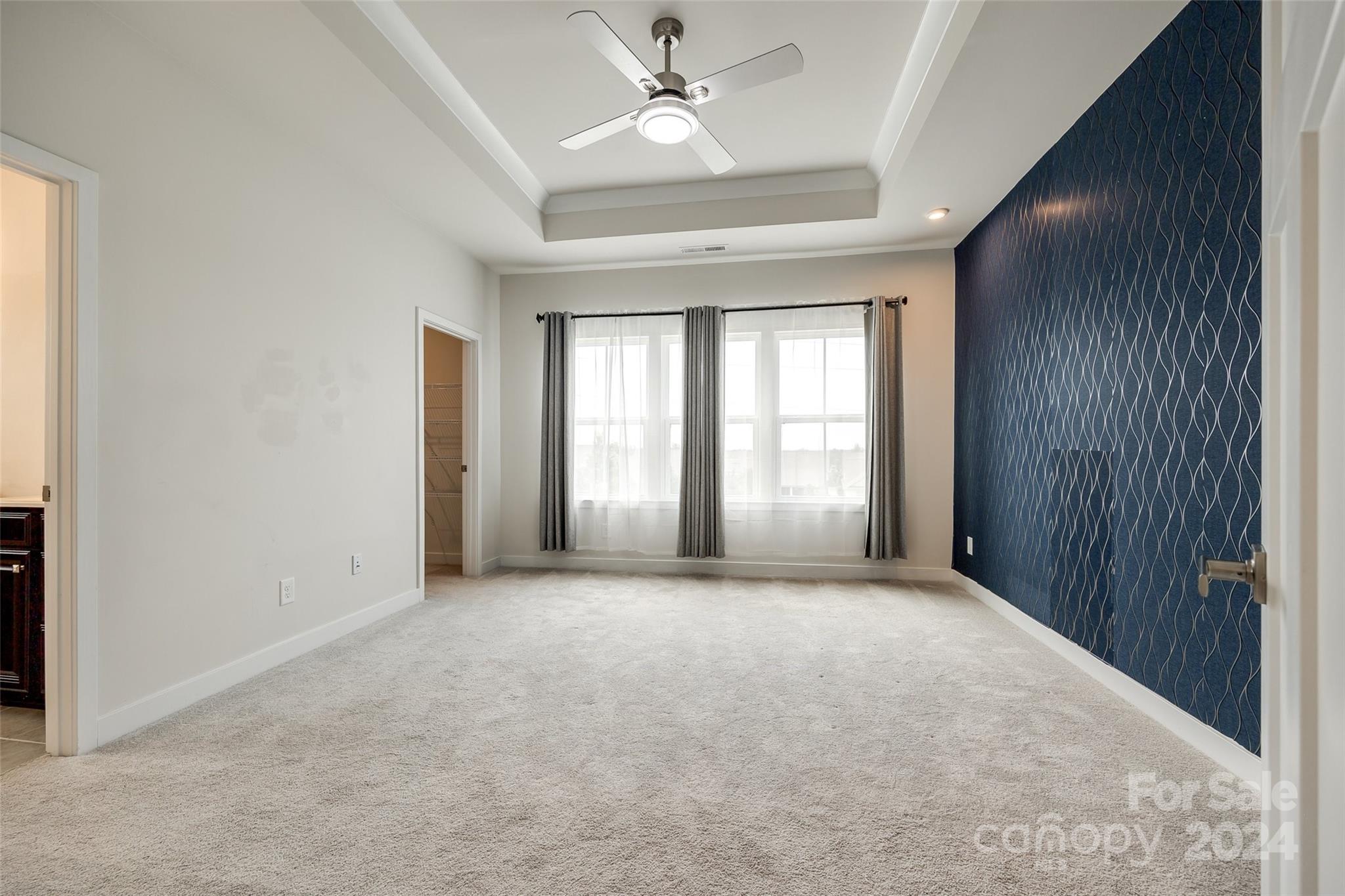 664 Crudent Road Tega Cay, SC 29708 - Photo 25 of 34 an empty room with windows and ceiling fan