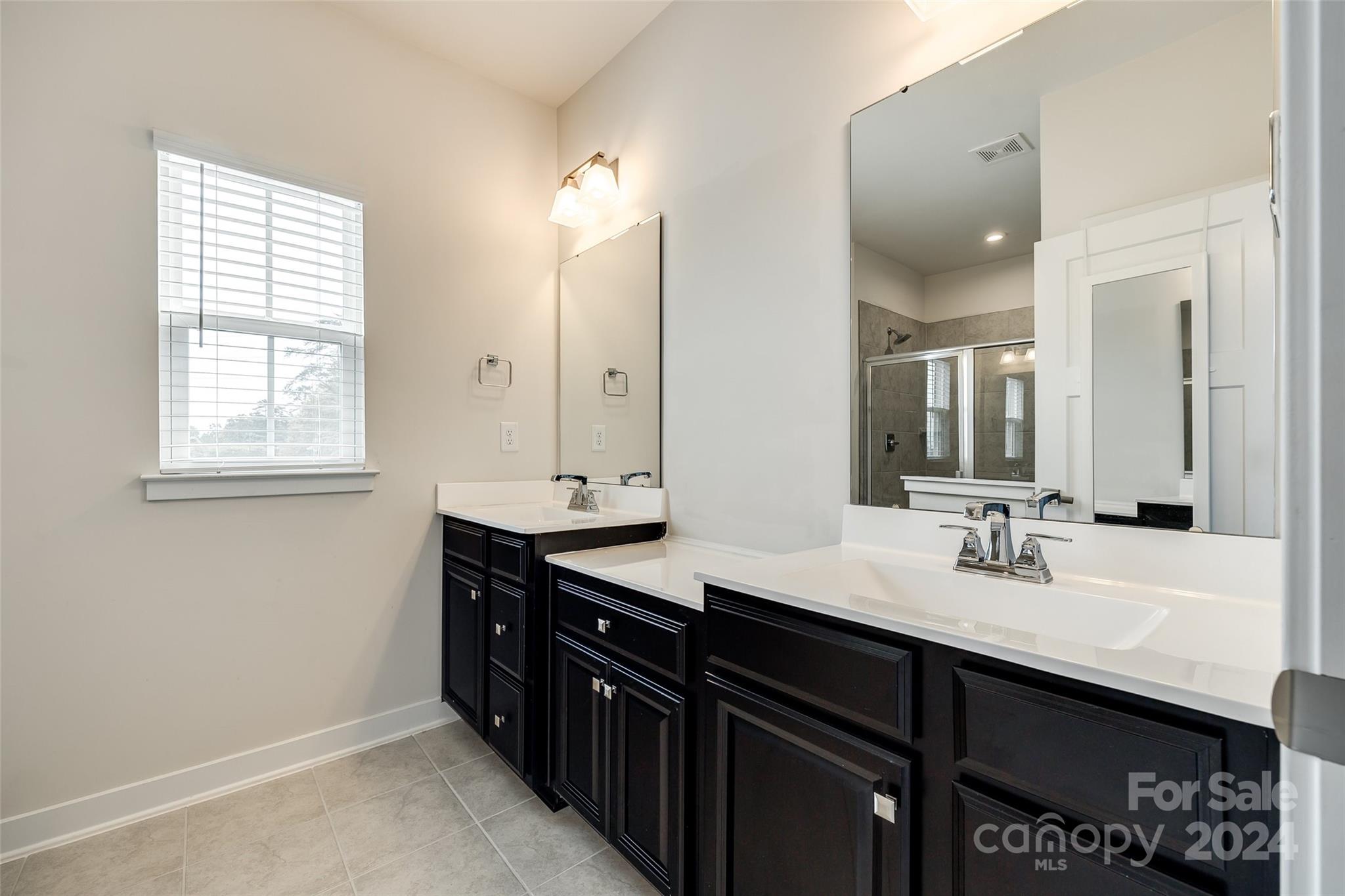 664 Crudent Road Tega Cay, SC 29708 - Photo 26 of 34 a bathroom with double sink and a mirror