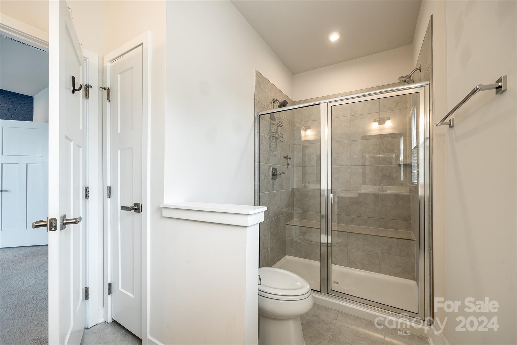 664 Crudent Road Tega Cay, SC 29708 - Photo 27 of 34 a bathroom with a shower and a toilet