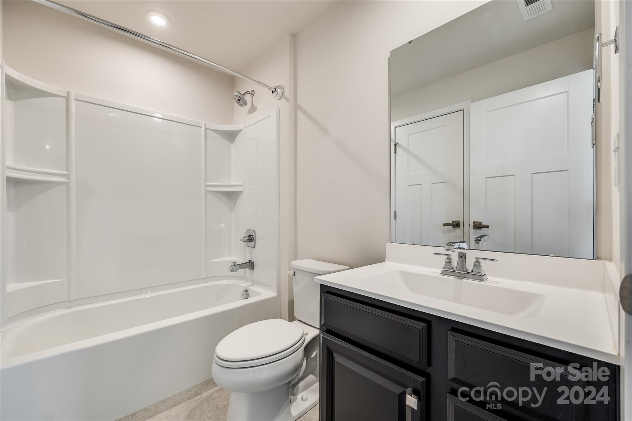 664 Crudent Road Tega Cay, SC 29708 - Photo 6 of 34 a bathroom with a sink a toilet and shower