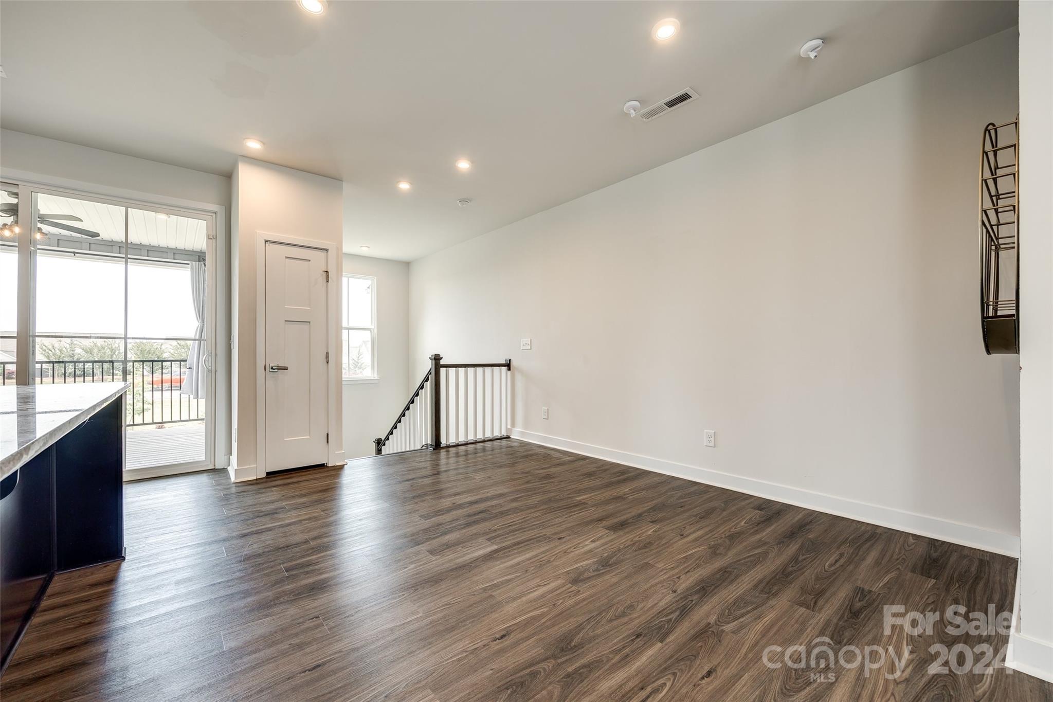 664 Crudent Road Tega Cay, SC 29708 - Photo 9 of 34 a view of an empty room with wooden floor and a window