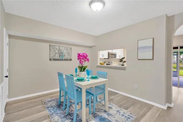 a dining room with furniture and wooden floor