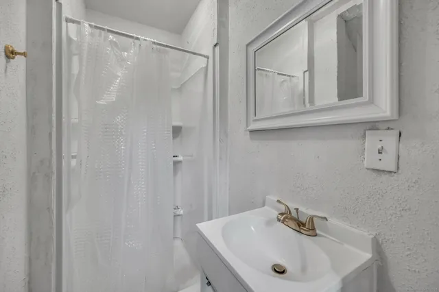 a bathroom with a sink and mirror