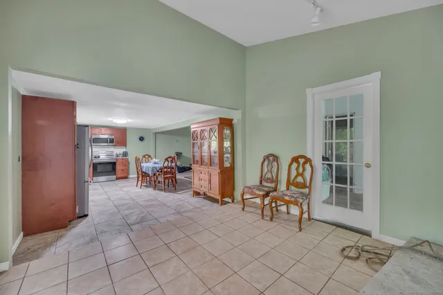 a view of a livingroom with furniture and bedroom