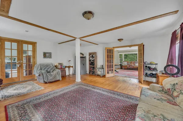 a living room with furniture and a wooden floor