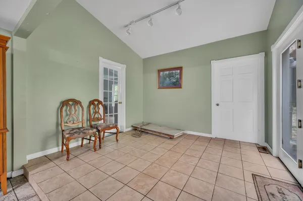 a view of a livingroom with furniture and bedroom