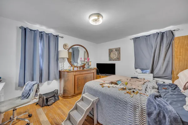 a bedroom that has a bed and a dresser in it