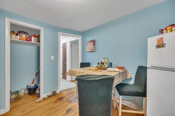 a dining room with furniture and wooden floor