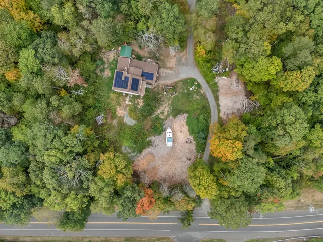 an aerial view of a house with yard