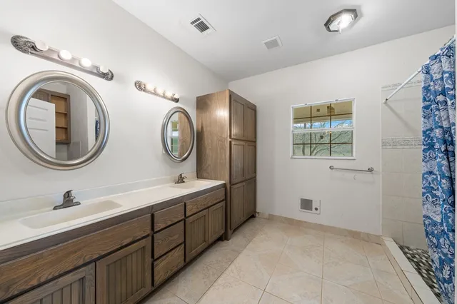 a kitchen with refrigerator cabinets and large window