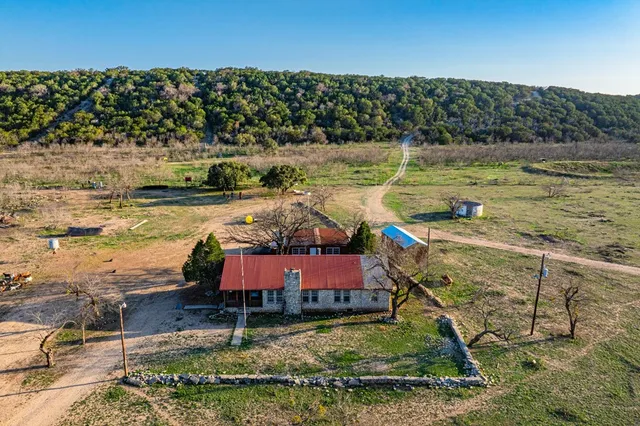 a bedroom with a large bed and a flat tv screen