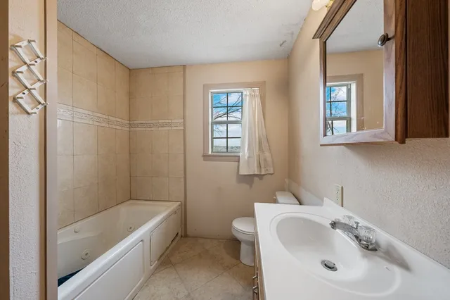 a view of a green field with an ocean view