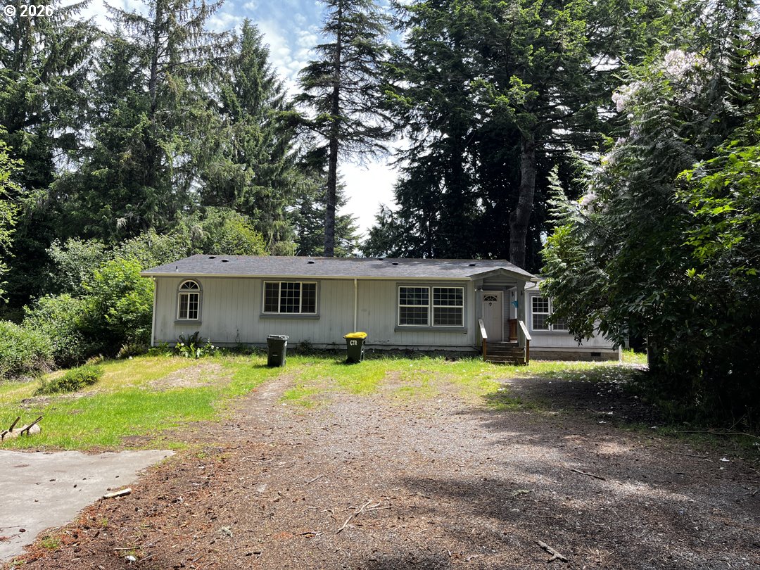 83411 Clear Lake Road Florence, OR 97439 - Photo 45 of 47 a view of a house with a yard and large trees