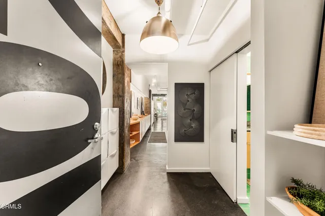 a living room with furniture and a painting on the wall