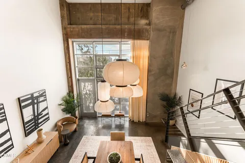 a bedroom with a bed next to a large window with the outer view