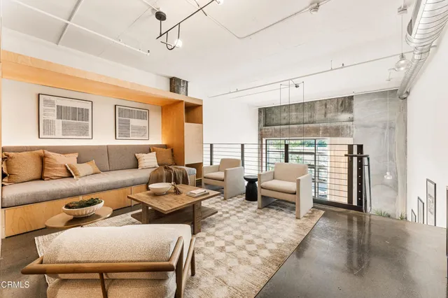 a bedroom with a bed and a potted plant on the dresser