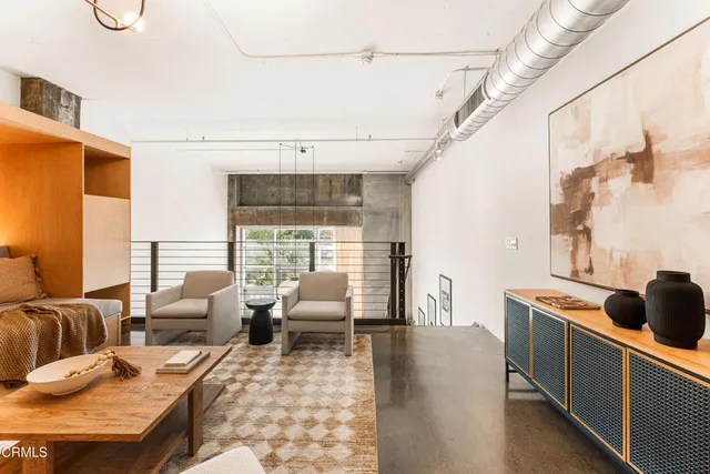 a spacious bedroom with a bed and a large mirror