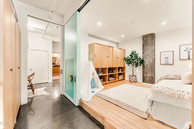 a view of bathroom with a potted plant on the counter and mirror