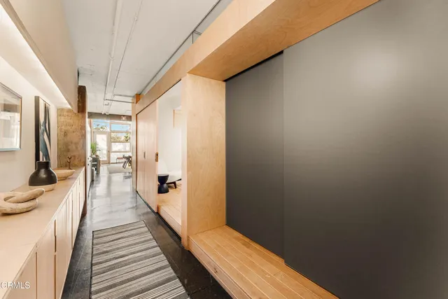 a spacious bedroom with a bed a table and potted plant