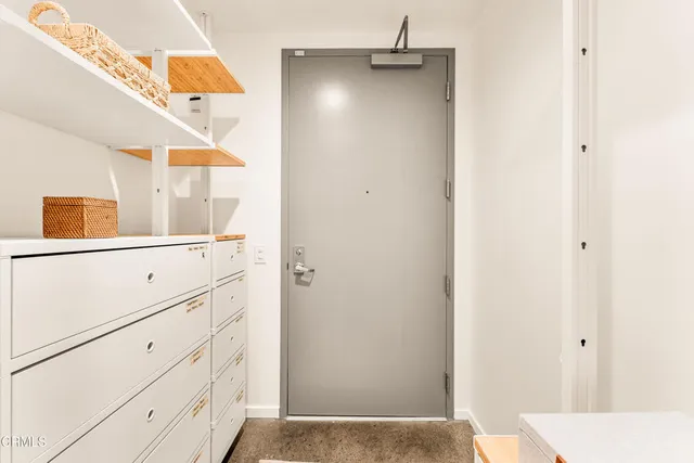 a view of a patio with couches table and chairs with wooden floor and fence