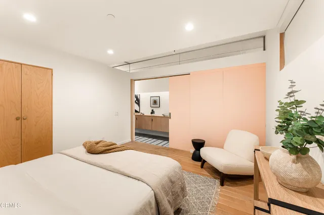 a large kitchen with kitchen island a large window a sink and stainless steel appliances