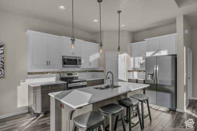 101 Chuckwalla Lane Springdale, UT 84767 - Photo 5 of 51 Kitchen featuring decorative backsplash, appliances with stainless steel finishes, pendant lighting, an island with sink, and a breakfast bar area