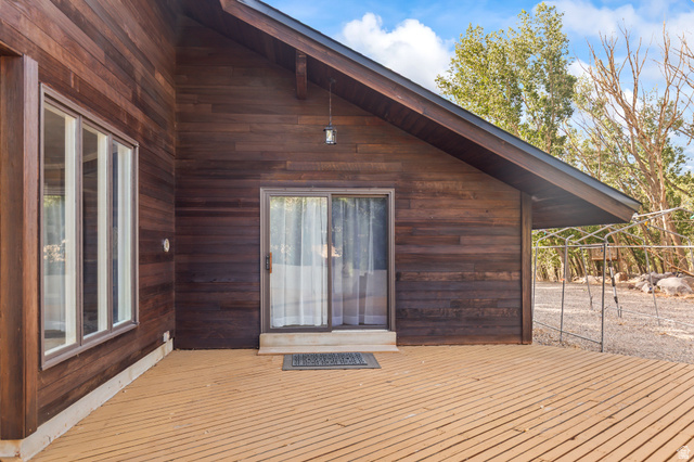 460 Omni Point Road Central Valley, UT 84754 - Photo 70 of 101 Wood-clad exterior featuring a pitched roofline, large window array, and sliding glass door