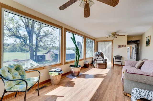 a living room with furniture and a floor to ceiling window