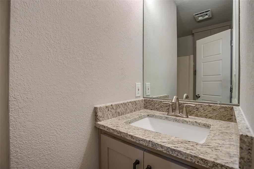 10311 Lone Pine Lane Fort Worth, TX 76108 - Photo 11 of 13 a bathroom with a granite countertop sink and a mirror