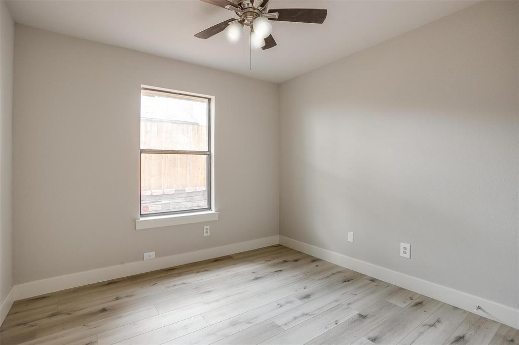 10311 Lone Pine Lane Fort Worth, TX 76108 - Photo 9 of 13 an empty room with a window and ceiling fan
