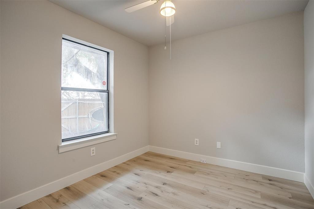 10311 Lone Pine Lane Fort Worth, TX 76108 - Photo 10 of 13 an empty room with wooden floor and windows
