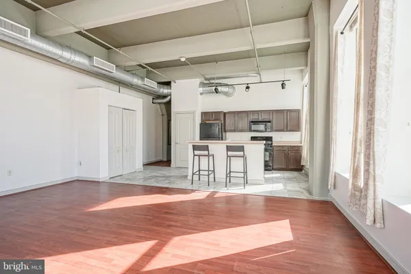 a view of a kitchen with wooden floor