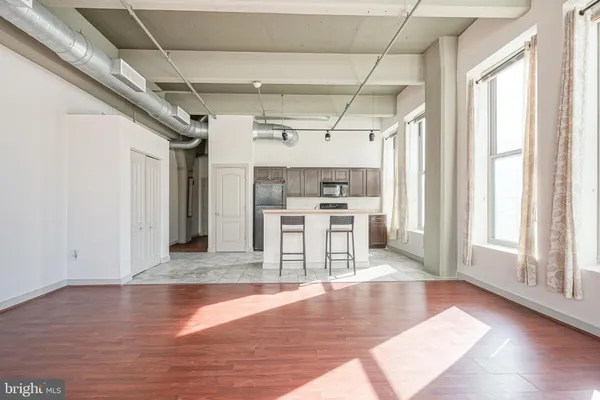 a view of a room with wooden floor and a window