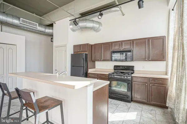 a kitchen with stainless steel appliances granite countertop a stove a refrigerator and a refrigerator