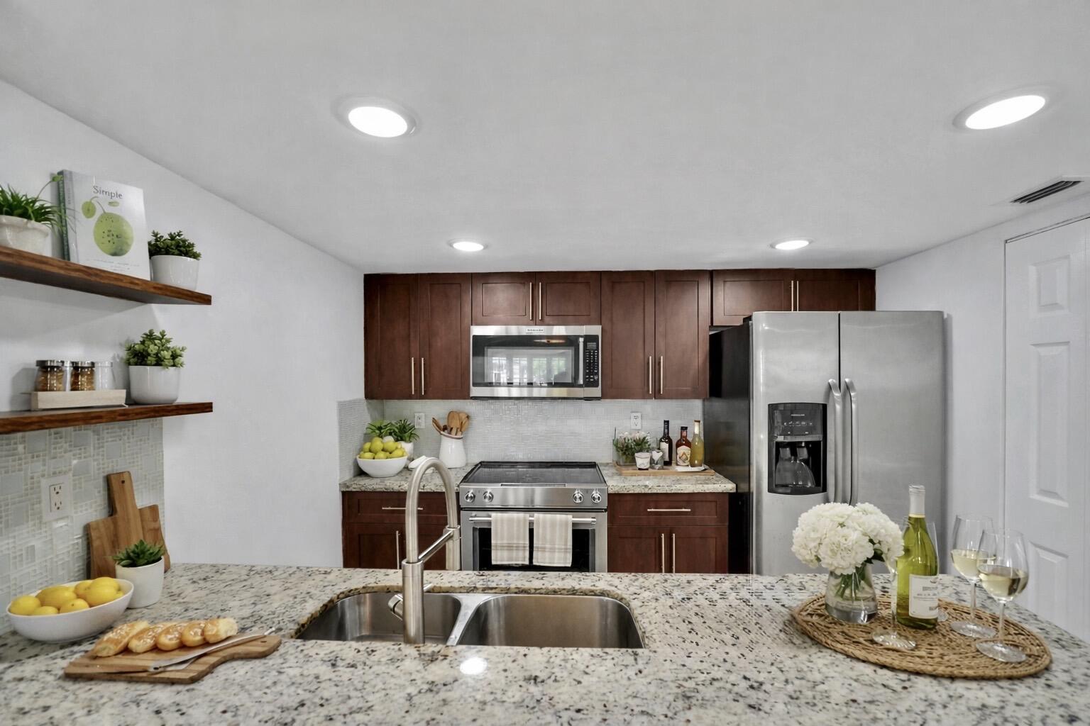 4550 Southwest 68th Ct Circle, Unit 548 Miami, FL 33155 - Photo 1 of 51 a kitchen with stainless steel appliances kitchen island granite countertop a refrigerator and a stove