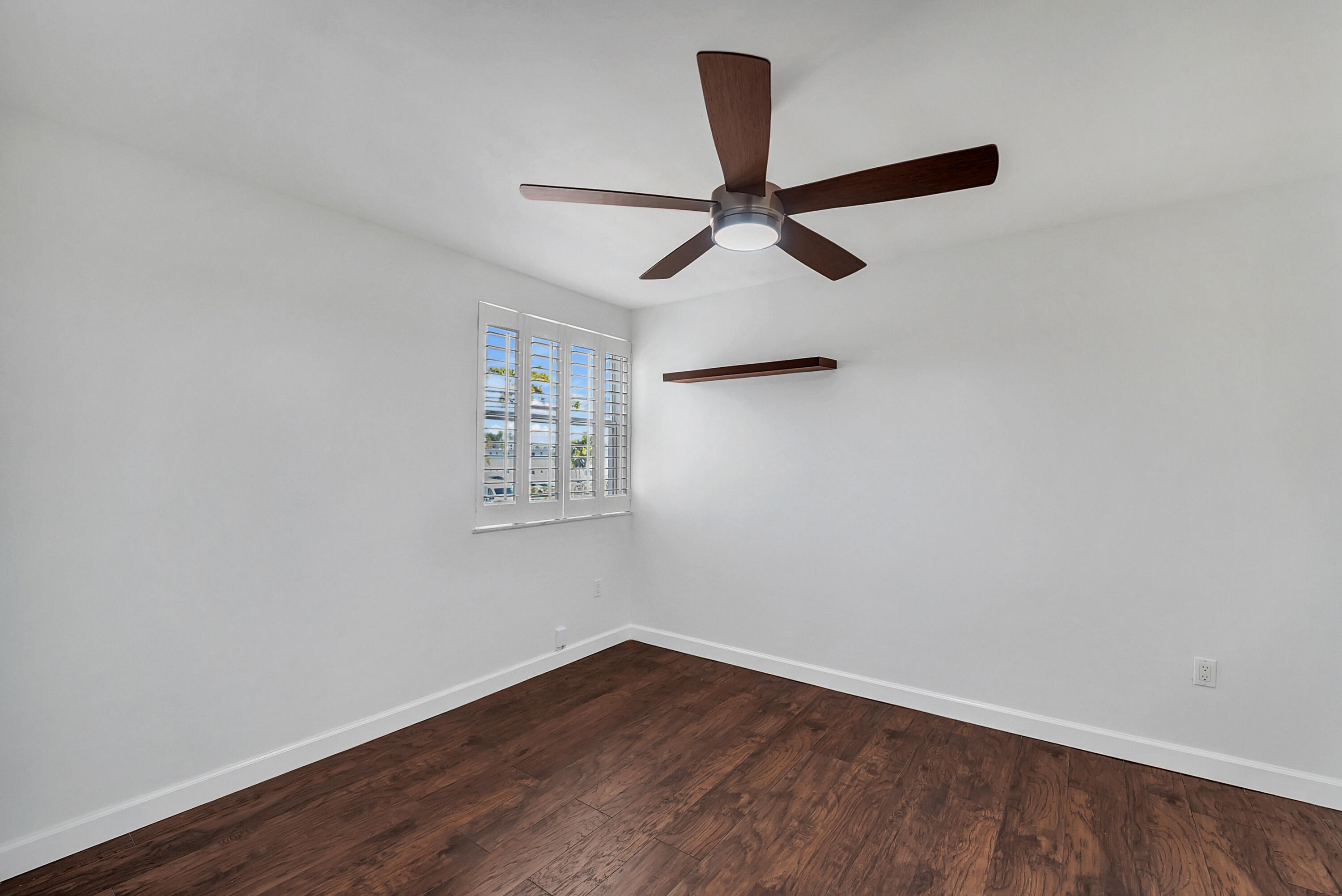 4550 Southwest 68th Ct Circle, Unit 548 Miami, FL 33155 - Photo 12 of 51 an empty room with wooden floor and ceiling fan