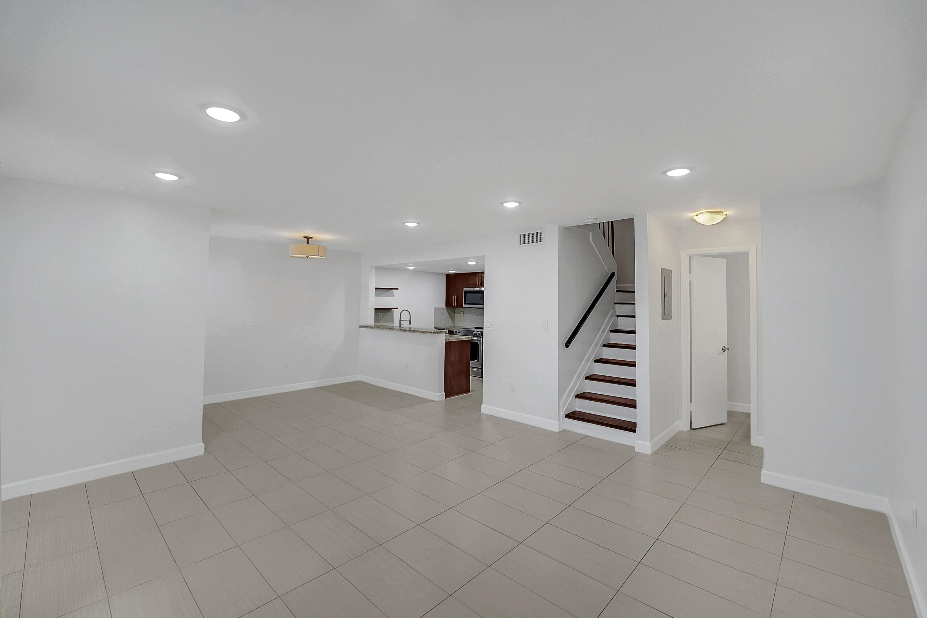 4550 Southwest 68th Ct Circle, Unit 548 Miami, FL 33155 - Photo 20 of 51 an empty room with wooden floor and stairs
