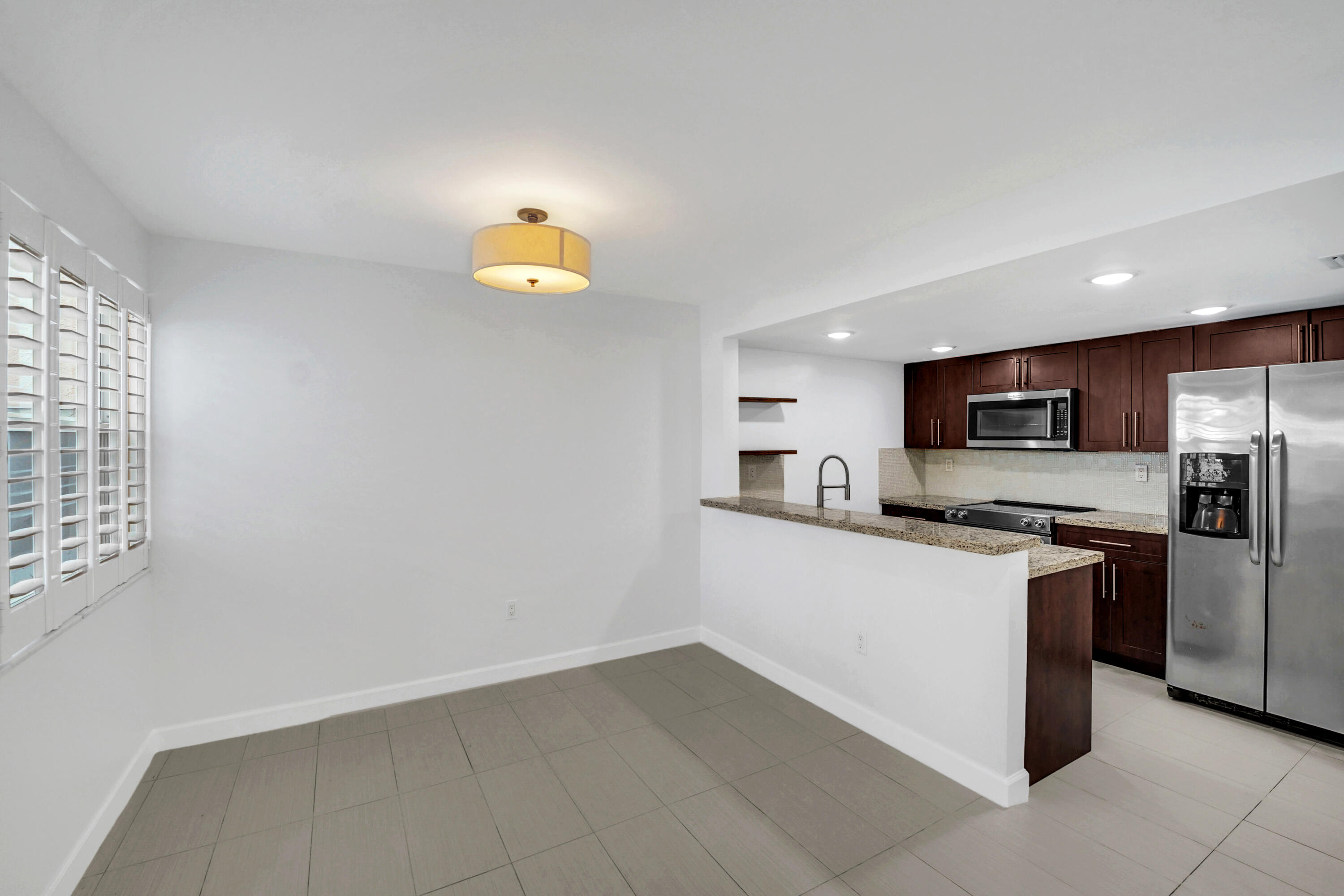 4550 Southwest 68th Ct Circle, Unit 548 Miami, FL 33155 - Photo 24 of 51 a kitchen with cabinets and stainless steel appliances