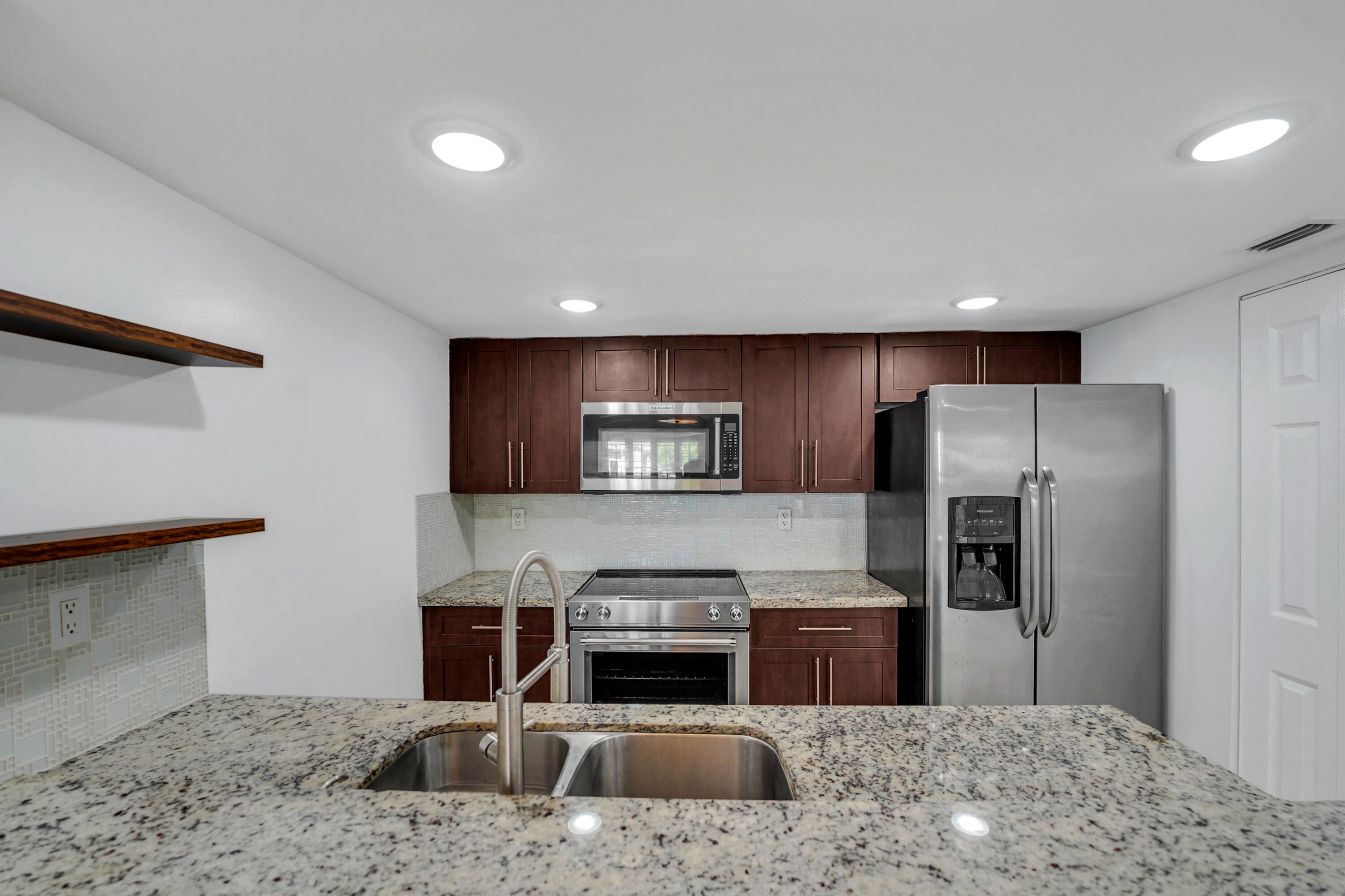 4550 Southwest 68th Ct Circle, Unit 548 Miami, FL 33155 - Photo 28 of 51 a kitchen with a refrigerator and a stove top oven