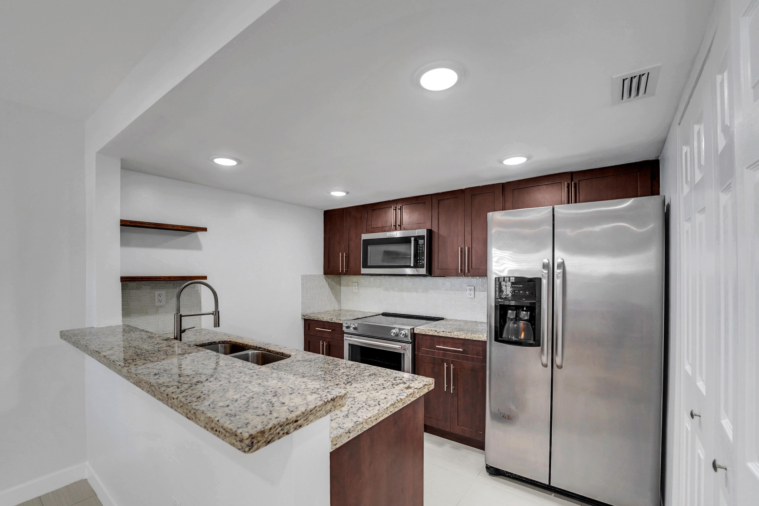 4550 Southwest 68th Ct Circle, Unit 548 Miami, FL 33155 - Photo 29 of 51 a kitchen with stainless steel appliances granite countertop a sink and a refrigerator