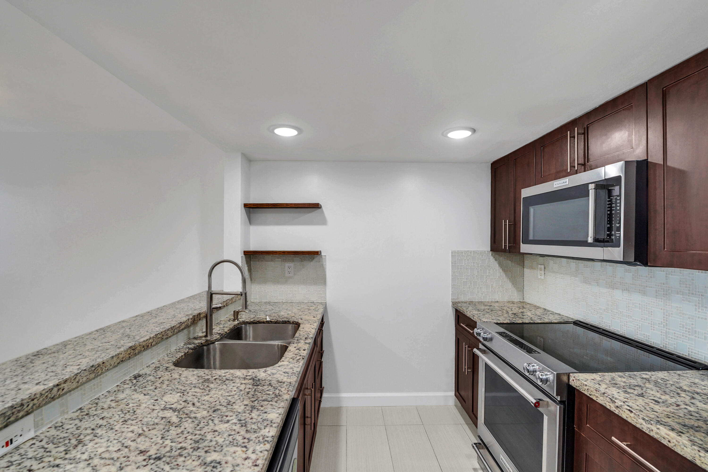 4550 Southwest 68th Ct Circle, Unit 548 Miami, FL 33155 - Photo 30 of 51 a kitchen with granite countertop a sink and a stove top oven