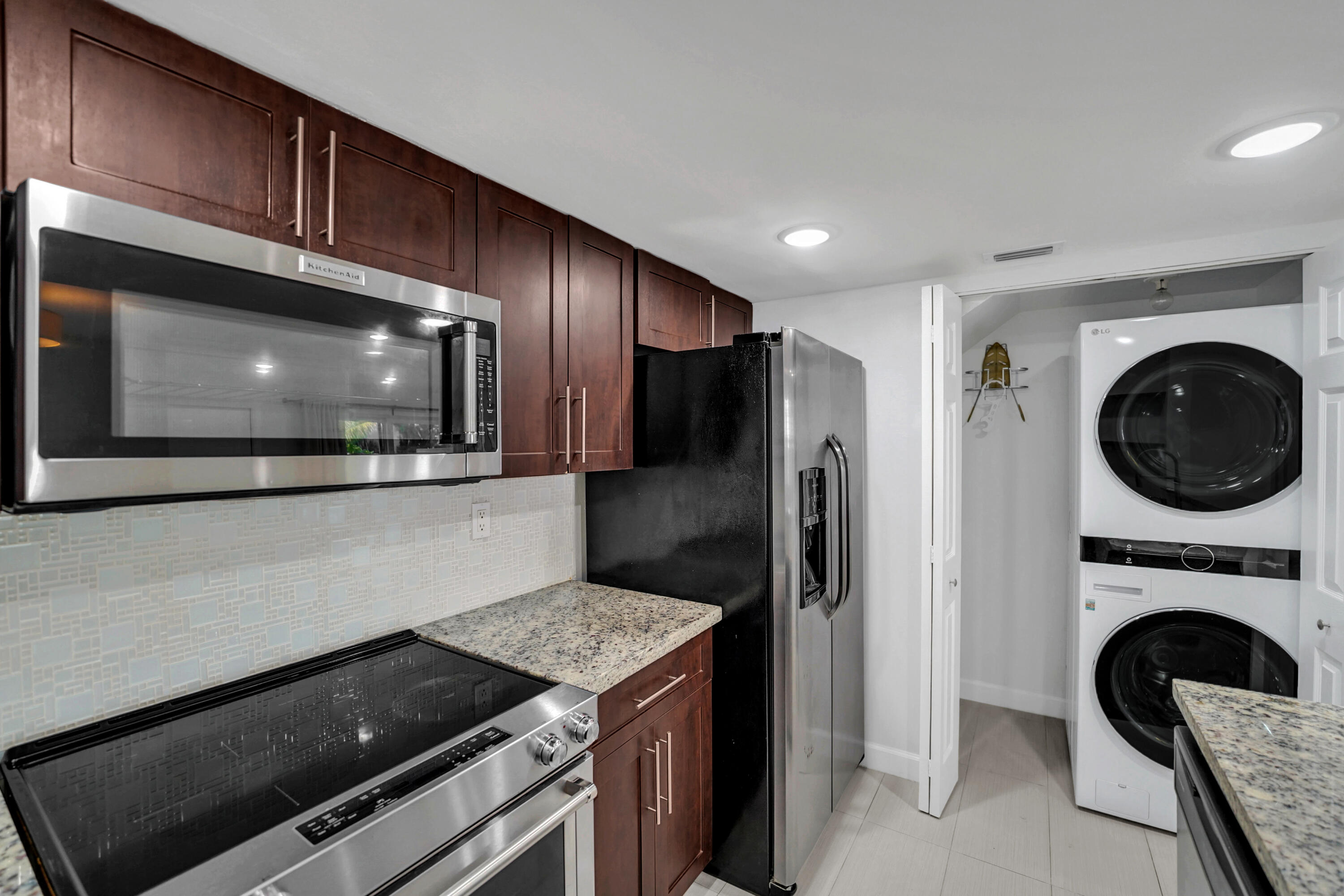 4550 Southwest 68th Ct Circle, Unit 548 Miami, FL 33155 - Photo 33 of 51 a kitchen with granite countertop cabinets stainless steel appliances and a counter top space