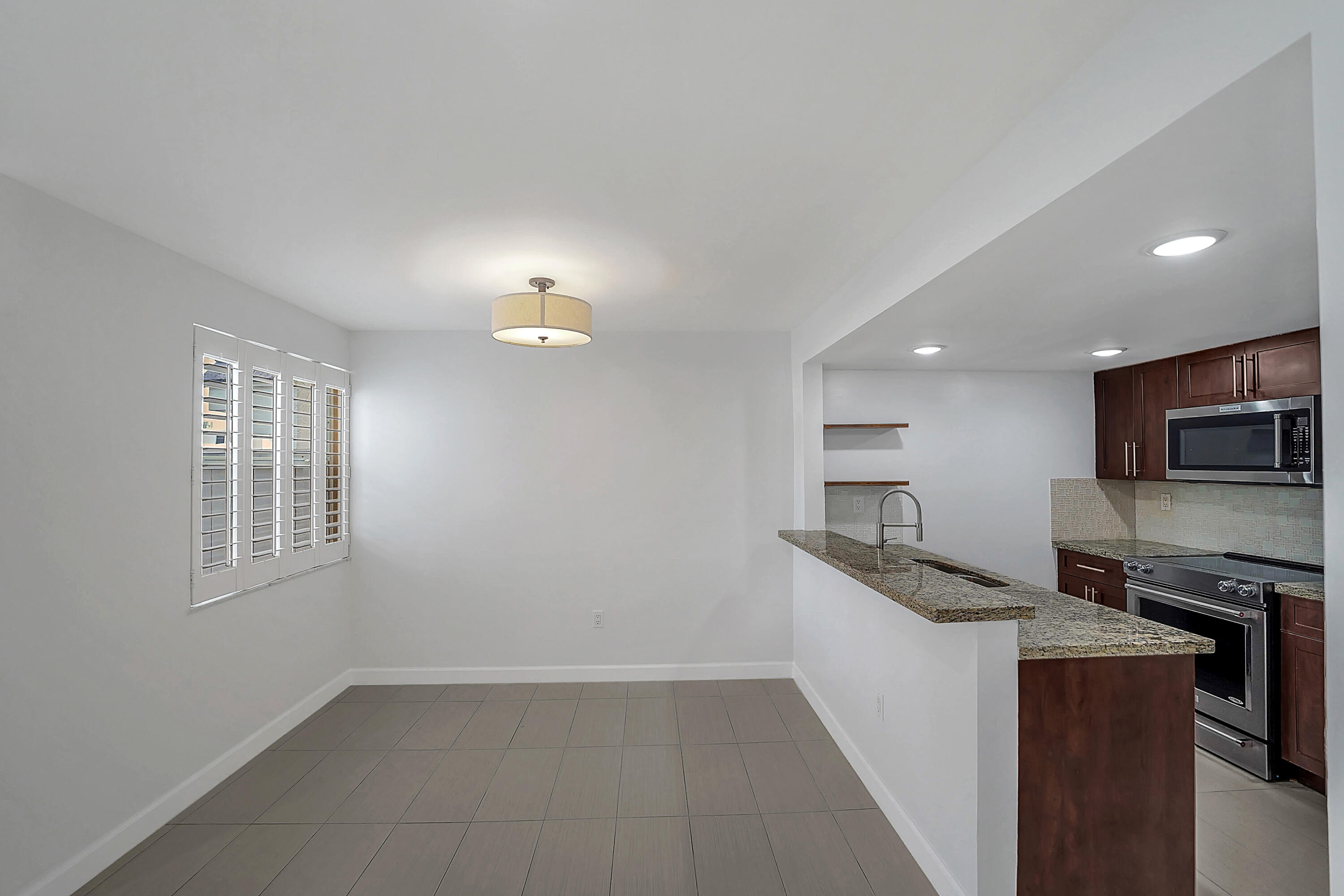 4550 Southwest 68th Ct Circle, Unit 548 Miami, FL 33155 - Photo 35 of 51 a kitchen with granite countertop a sink and steel appliances